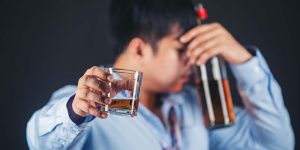 Handsome handsome man drinking whisky at home